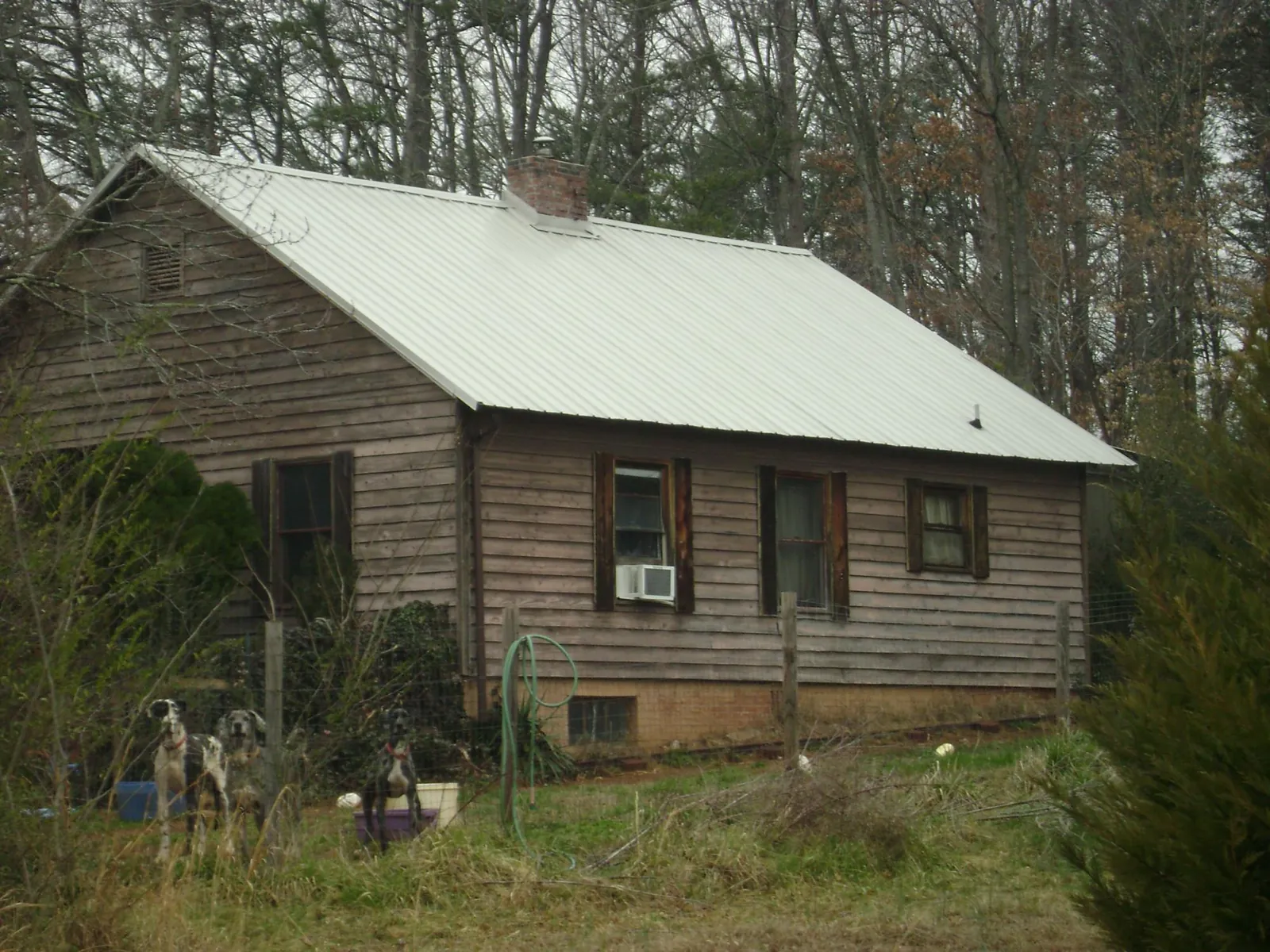 White metal roof on an old wood sided farmhouse, from a Metal Roof Installation job in Mc Veytown